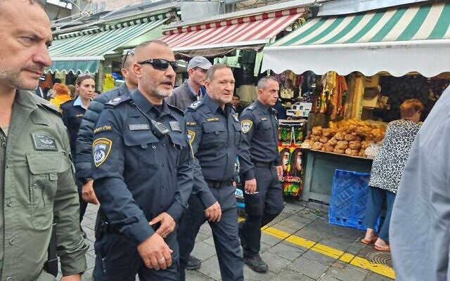 Illustrative: Police Commissioner Kobi Shabtai (center) and colleagues patrol in Jerusalem's Mahane Yehuda market, November 25, 2022. (Police spokeperson)