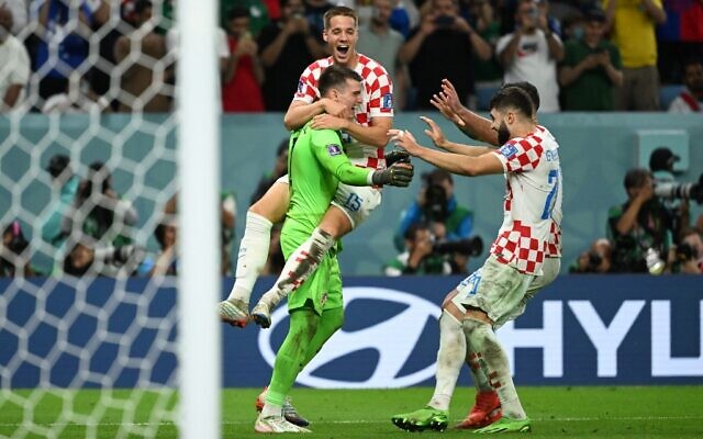 Croatia's goalkeeper Dominik Livakovic celebrates with teammates after their victory in the Qatar 2022 World Cup round of 16 football match between Japan and Croatia at the Al-Janoub Stadium in Al-Wakrah, south of Doha on December 5, 2022. (Ina Fassbender / AFP)