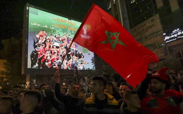 Palestinians celebrate Morocco's win over Portugal in the streets of the West Bank city of Hebron after the Qatar 2022 World Cup quarter-final soccer match between Morocco and Portugal on December 10, 2022. (HAZEM BADER / AFP)