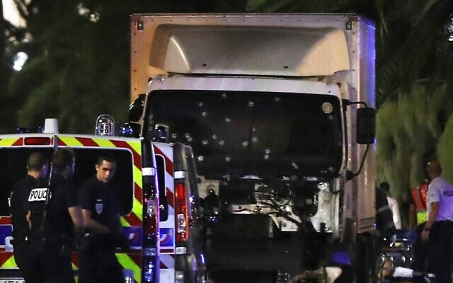 In this file photo taken on July 14, 2016, French police officers stand near a truck drove by a terrorist who plowed into a crowd leaving a fireworks display in the French Riviera town of Nice, killing 86 people. (Valery Hache/AFP)