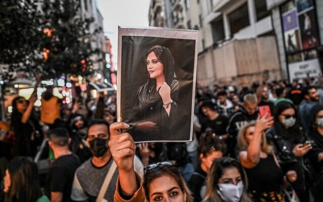 A protester holds a portrait of Mahsa Amini during a demonstration in support of Amini, a young Iranian woman who died after being arrested in Tehran by the Islamic Republic's morality police, on Istiklal avenue in Istanbul on September 20, 2022. (Ozan Kose/AFP)