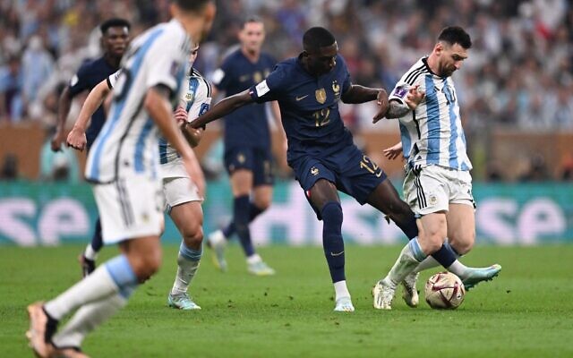 France's forward #12 Randal Kolo Muani (C) challenges Argentina's forward #10 Lionel Messi during the Qatar 2022 World Cup final football match between Argentina and France at Lusail Stadium in Lusail, north of Doha on December 18, 2022. (Kirill KUDRYAVTSEV / AFP)