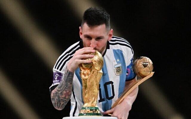 Argentina's captain and forward #10 Lionel Messi kisses the FIFA World Cup Trophy during the trophy ceremony after his team won the Qatar 2022 World Cup final football match against France at Lusail Stadium in Lusail, north of Doha on December 18, 2022. (Kirill KUDRYAVTSEV/AFP)