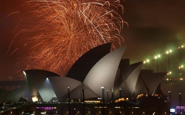 The 'family fireworks' displayed three hours before midnight every year ahead of the main show at midnight, fill the sky over the Opera House in Sydney on New Year's Eve on December 31, 2022. (David Gray/AFP)