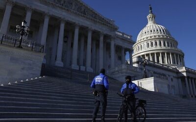 US Capitol Police officers stand at the base of the steps to the House Chambers as the House votes on a $1.7 trillion spending package on December 23, 2022 in Washington. The House of Representatives voted to pass the spending bill that will fund the government through 2023. (Anna Moneymaker/Getty Images/AFP)