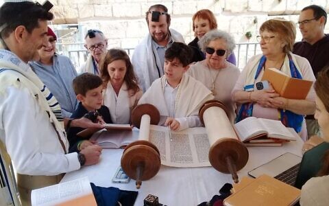 A boy reads from the Torah as part of his barmitzvah at the Western Wall's egalitarian section in Jerusalem on November 17, 2022. (Egalitarian section/Facebook)