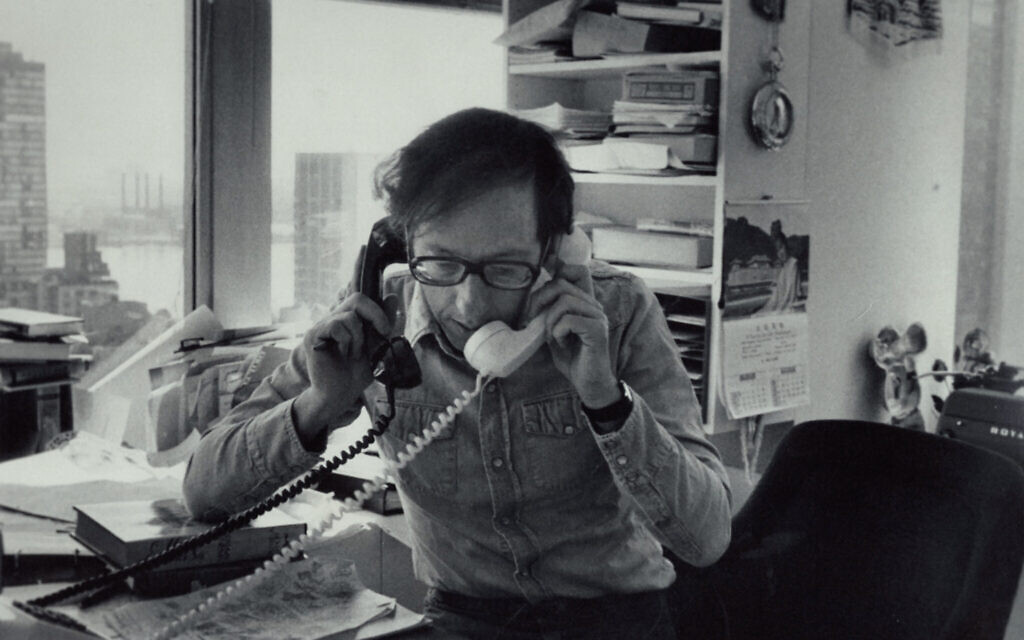 Robert Gottlieb holding two phones in an undated photo. (Thomas Victor/ Courtesy of the Estate of Thomas Victor, LLC / Sony Pictures Classics)