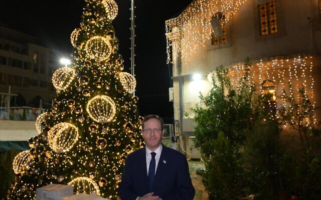 President Isaac Herzog at a Christmas tree-lighting ceremony in Jaffa on December 21, 2022. (Amos Ben-Gershom/GPO)