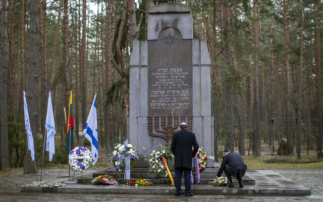 Illustrative: US Ambassador to the Lithuania Robert S. Gilchrist, left, pauses after laying a wreath at the Holocaust memorial at Paneriai during the ceremony marking the annual Holocaust Remembrance Day in Vilnius, Lithuania, April 8, 2021. (AP Photo/Mindaugas Kulbis)