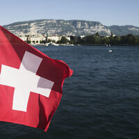 The Switzerland national flag waves in the wind on Lake Geneva in Geneva, Switzerland Sunday, June 13, 2021. (Markus Schreiber/AP)
