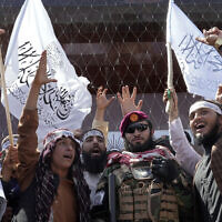 Taliban fighters chant slogans during a celebration marking the first anniversary of the withdrawal of US-led troops from Afghanistan, in front of the US Embassy in Kabul, Afghanistan, August 31, 2022. (AP Photo/Ebrahim Noroozi)