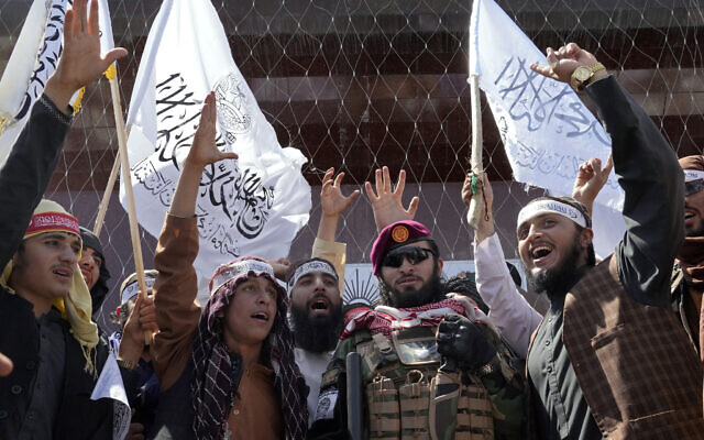 Taliban fighters chant slogans during a celebration marking the first anniversary of the withdrawal of US-led troops from Afghanistan, in front of the US Embassy in Kabul, Afghanistan, August 31, 2022. (AP Photo/Ebrahim Noroozi)