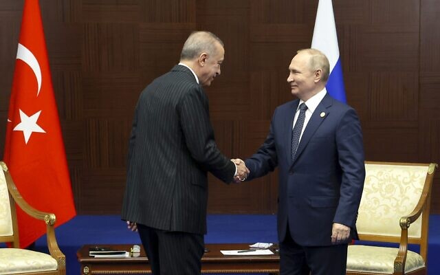 Illustrative: Russian President Vladimir Putin, right, and Turkey's President Recep Tayyip Erdogan shake hands during their meeting on sidelines of the Conference on Interaction and Confidence Building Measures in Asia (CICA) summit, in Astana, Kazakhstan, October 13, 2022. (Vyacheslav Prokofyev, Sputnik, Kremlin Pool Photo via AP)