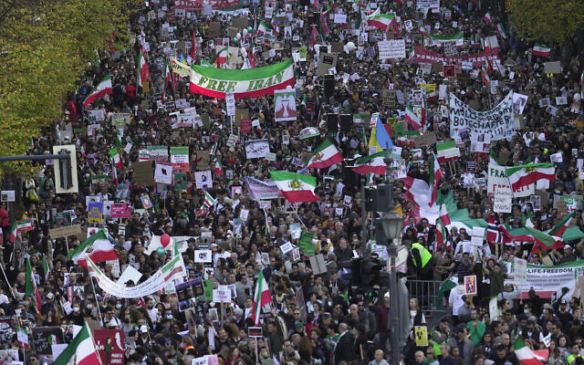 People attend a protest against the Iranian regime, in Berlin, Germany, October 22, 2022, following the death of Mahsa Amini in the custody of the Islamic Republic's notorious "morality police." (AP Photo/Markus Schreiber)