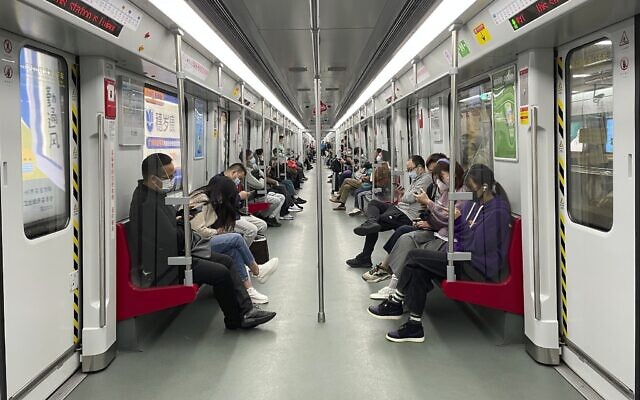 Residents ride public transport in the district of Haizhu as pandemic restrictions are eased in southern China's Guangzhou province, December 1, 2022. (AP Photo)