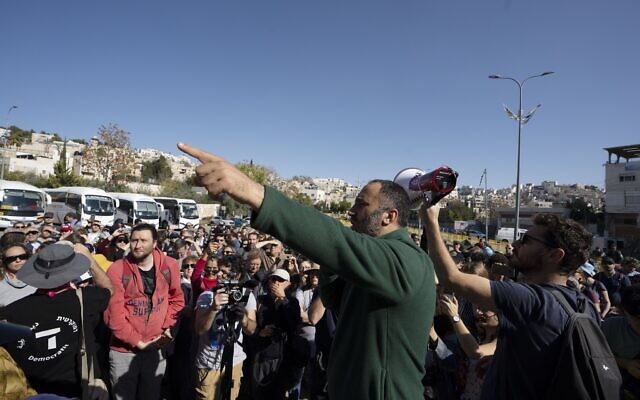 Palestinian activist Issa Amro speaks to Israeli activists in the West Bank city of Hebron, Friday, Dec. 2, 2022 (AP Photo/Maya Alleruzzo)