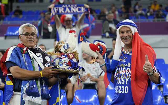 FILE - Fans of France cheer prior to the World Cup group D soccer match between France and Denmark at the Stadium 974 in Doha, Qatar, Saturday, Nov. 26, 2022.  At a World Cup that has become a political lightning rod, it comes as no surprise that soccer fans’ sartorial style has sparked controversy. At the first World Cup in the Middle East, fans from around the world have refashioned traditional Gulf Arab headdresses and thobes. (AP Photo/Martin Meissner, File)