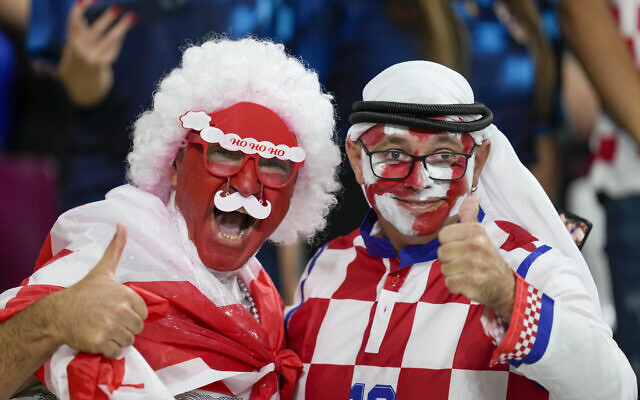 Croatia and Canada fans cheer ahead of the World Cup group F soccer match between Croatia and Canada, at the Khalifa International Stadium in Doha, Qatar, Sunday, Nov. 27, 2022.  At a World Cup that has become a political lightning rod, it comes as no surprise that soccer fans’ sartorial style has sparked controversy. At the first World Cup in the Middle East, fans from around the world have refashioned traditional Gulf Arab headdresses and thobes. (AP Photo/Darko Vojinovic, File)