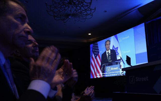 Audience members applaud as US Secretary of State Antony Blinken is seen on a large screen as he speaks at the J Street National Conference at the Omni Shoreham Hotel in Washington, Dec. 4, 2022. (AP Photo/Carolyn Kaster)