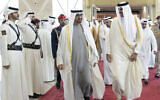 Qatari Emir Sheikh Tamim bin Hamad Al-Thani, right, greats UAE president Sheikh Mohamed bin Zayed Al Nahyan, upon his arrival at the Hamad airport in Doha, Qatar, December 5, 2022. (Qatar Amiri Diwan via AP)