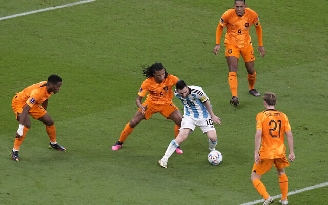 Argentina's Lionel Messi, center, challenges for the ball with Denzel Dumfries of the Netherlands, left, Nathan Ake of the Netherlands, second left, Frenkie de Jong of the Netherlands, bottom right, Virgil van Dijk of the Netherlands, top right, during the World Cup quarterfinal soccer match between the Netherlands and Argentina, at the Lusail Stadium in Lusail, Qatar, Friday, Dec. 9, 2022. (AP/Thanassis Stavrakis)