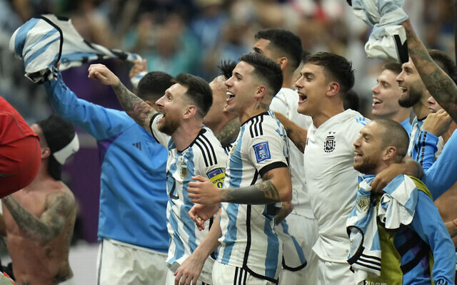 Argentina's Lionel Messi, left, celebrates with teammates after defeating the Netherlands off penalties during the World Cup quarterfinal soccer match between the Netherlands and Argentina, at the Lusail Stadium in Lusail, Qatar, Saturday, Dec. 10, 2022. (AP/Francisco Seco)
