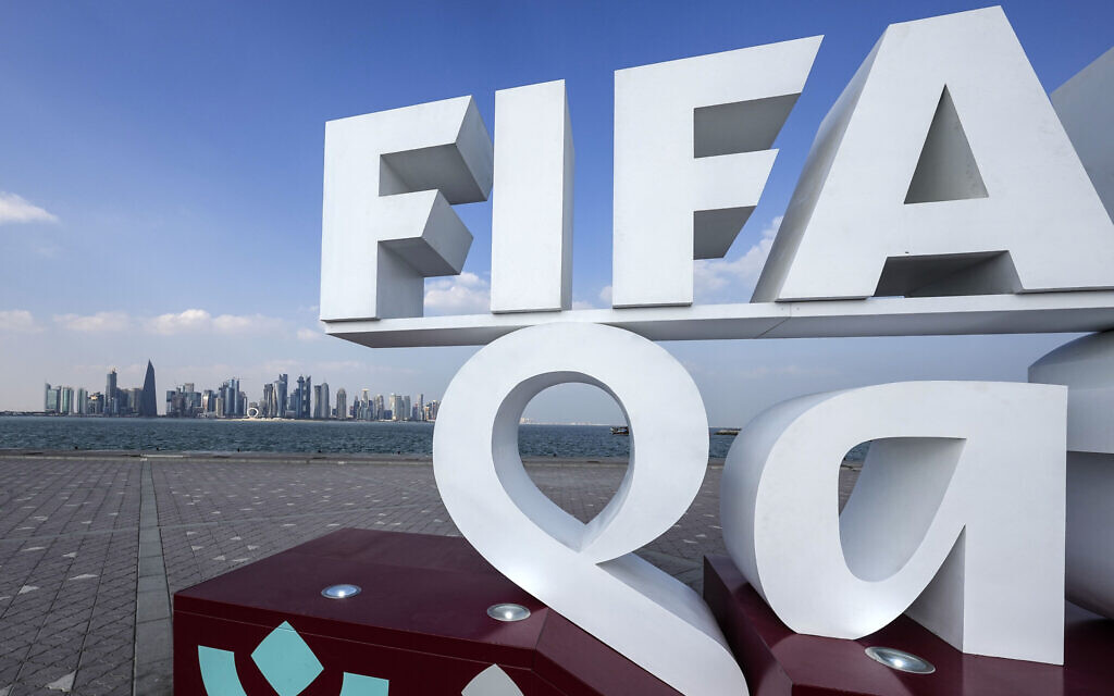 A FIFA lettering is pictured in front of the Doha skyline during the Soccer World Cup in central Doha, Qatar, on December 12, 2022. (AP Photo/Martin Meissner)