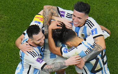 Argentina players celebrate with Argentina's Lionel Messi, left, who scored his side's first goal with a penalty shot during the World Cup semifinal soccer match between Argentina and Croatia at the Lusail Stadium in Lusail, Qatar, December 13, 2022. (AP Photo/Hassan Ammar)
