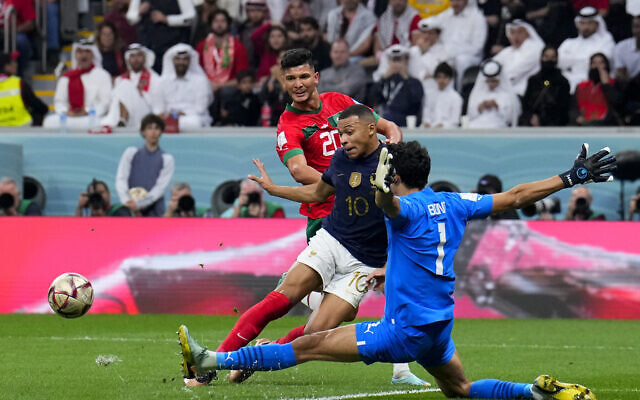Morocco’s goalkeeper Yassine Bounou cuts off an attack of France’s Kylian Mbappe during the World Cup semifinal soccer match between France and Morocco at the Al Bayt Stadium in Al Khor, Qatar, Wednesday, Dec. 14, 2022. (AP Photo/Natacha Pisarenko)