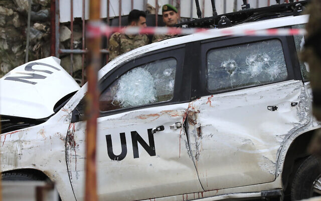 Lebanese soldiers stand behind a damaged UNIFIL vehicle at the scene where a peacekeeper convoy came under gunfire in the Al-Aqbiya village, south Lebanon, December 15, 2022. (AP/Mohammed Zaatari)