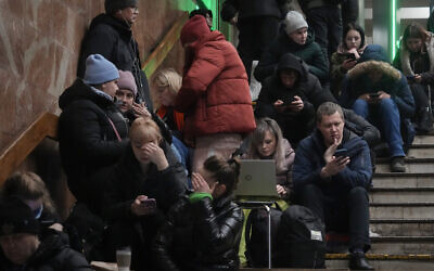 People take cover in the subway station being used as a bomb shelter during a rocket attack in Kyiv, Ukraine, December 16, 2022. (AP/Efrem Lukatsky)