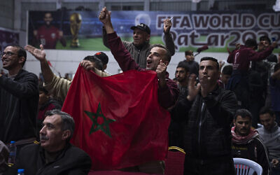 Palestinians react as they watch a live broadcast of the World Cup third-place playoff soccer match between Morocco and Croatia played in Qatar, in Gaza City, December 17, 2022. (AP Photo/Fatima Shbair)