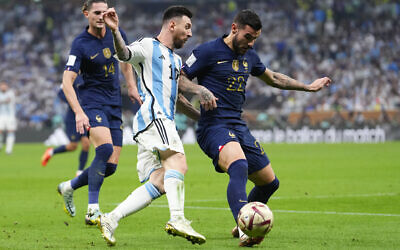 France's Theo Hernandez, right, and Argentina's Lionel Messi vie for the ball during the World Cup final soccer match between Argentina and France at the Lusail Stadium in Lusail, Qatar, December 18, 2022. (AP Photo/Manu Fernandez)
