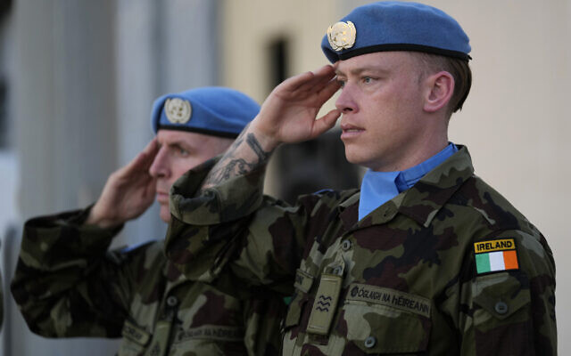 Irish UN peacekeepers, salute at the memorial procession of their comrade Pvt. Seán Rooney, at Beirut airport, Dec. 18, 2022. (AP Photo/Hussein Malla)