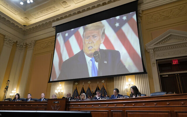 A video of former President Donald Trump is shown on a screen, as the House select committee investigating the January 6 attack on the US Capitol holds its final meeting on Capitol Hill in Washington, December 19, 2022. (AP Photo/J. Scott Applewhite)