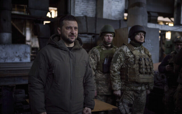 In this photo provided by the Ukrainian Presidential Press Office, Ukrainian President Volodymyr Zelensky (L) speaks to soldiers at the site of the heaviest battles with the Russian invaders in Bakhmut, Ukraine, December 20, 2022. (Ukrainian Presidential Press Office via AP)