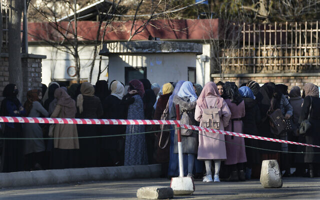 Afghan students line up at one of Kabul University's gates in Kabul, Afghanistan, February 26, 2022. (Hussein Malla/AP)