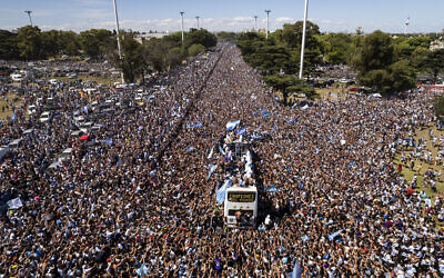The Argentine soccer team that won the World Cup title ride on an open bus during their homecoming parade in Buenos Aires, Argentina, December 20, 2022. (AP Photo/Rodrigo Abd)