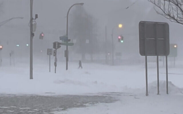 High winds and snow covers the streets and vehicles in Buffalo, N.Y. on Sunday, Dec. 25, 2022. (WKBW via AP)