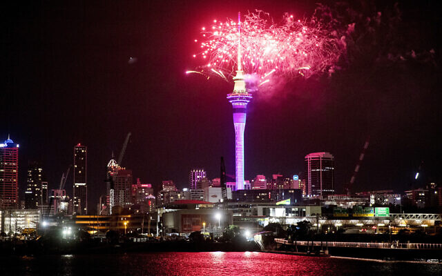 Fireworks explode over Sky Tower in central Auckland as New Year celebrations begin in New Zealand, January 1, 2023. (Dean Purcel/NZ Herald via AP)
