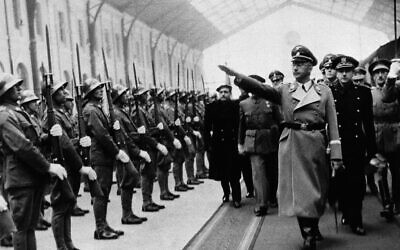 Heinrich Himmler, chief of Hitler's police, gives the Nazi salute at the Madrid Railway Station on arrival for his visit with Count Mayalde, Chief of Spanish Department of Security, Oct. 20, 1940.  (AP)