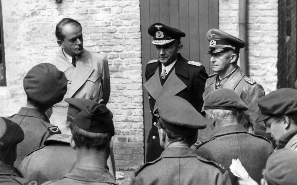 Following their arrest at Flensburg, Germany on May 24, 1945, Admiral Karl Doenitz and aides answer questions of war correspondents. Left to right: Reich Production Minister Albert Speer, Grand Admiral Karl Doenitz and Col. General Gustav Jodl. (AP Photo/Henry Griffin)