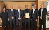 Bank of Israel governor Amir Yaron (third from left) hands conditional bank license to Shmuel Hauser (third from right), chairman of a new digital banking venture led by Nir Zuk, the founder of cybersecurity giant Palo Alto Networks.  (Courtesy/Bank of Israel)
