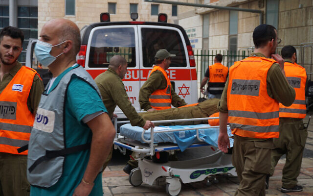 IDF Home Front Command soldiers escort mock victims into the Hadassah Ein Kerem hospital in Jerusalem, during a drill, December 15, 2022. (Emanuel Fabian/Times of Israel)