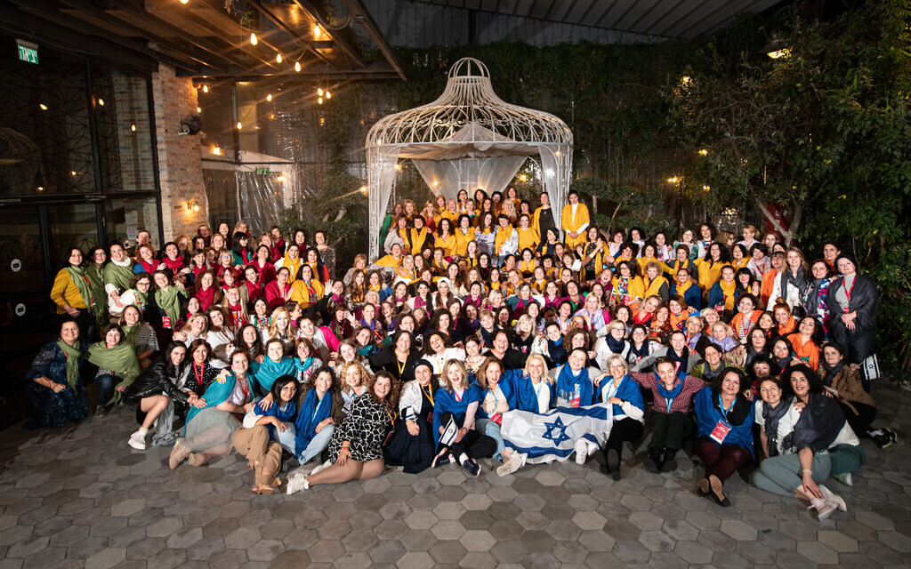 Women from Russia, Ukraine, Estonia, Latvia and Germany visiting Israel as part of the Momentum program pose for a photograph in December 2022. (Aviram Valdman/Momentum)