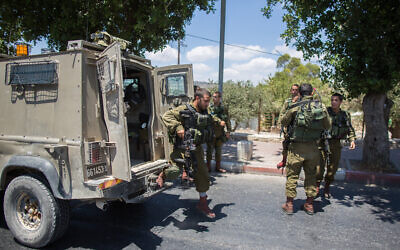 Illustrative: Israeli soldiers near the scene of a stabbing attack near a checkpoint between Jerusalem and the West Bank city of Bethlehem, June 29, 2015. (Yonatan Sindel/Flash90)