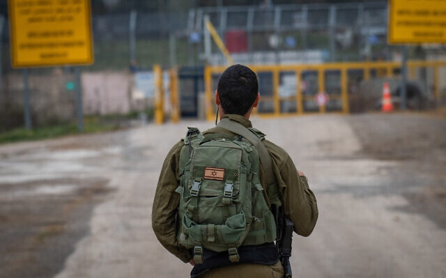 Illustrative: An Israeli soldier stands guard on the Israel's side of the Quneitra crossing on the Syrian border, in the Golan Heights, March 23, 2019. (Basel Awidat/Flash90)