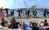 Climate activists protest against offshore drilling, at the beach in Tel Aviv, on August 13, 2022. (Tomer Neuberg/Flash90)