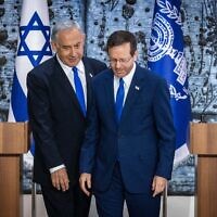 President Isaac Herzog, right, grants Likud party chairman MK Benjamin Netanyahu the mandate to form a new government, at the President's Residence in Jerusalem on November 13, 2022. (Olivier Fitoussi/Flash90)