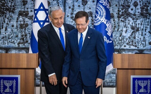 President Isaac Herzog, right, grants Likud party chairman MK Benjamin Netanyahu the mandate to form a new government, at the President's Residence in Jerusalem on November 13, 2022. (Olivier Fitoussi/Flash90)